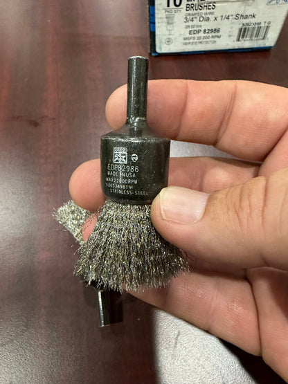 PFERD 82986 3/4 inch crimped stainless steel wire end brush with 1/4 inch shank, close-up of EDP 82986 markings